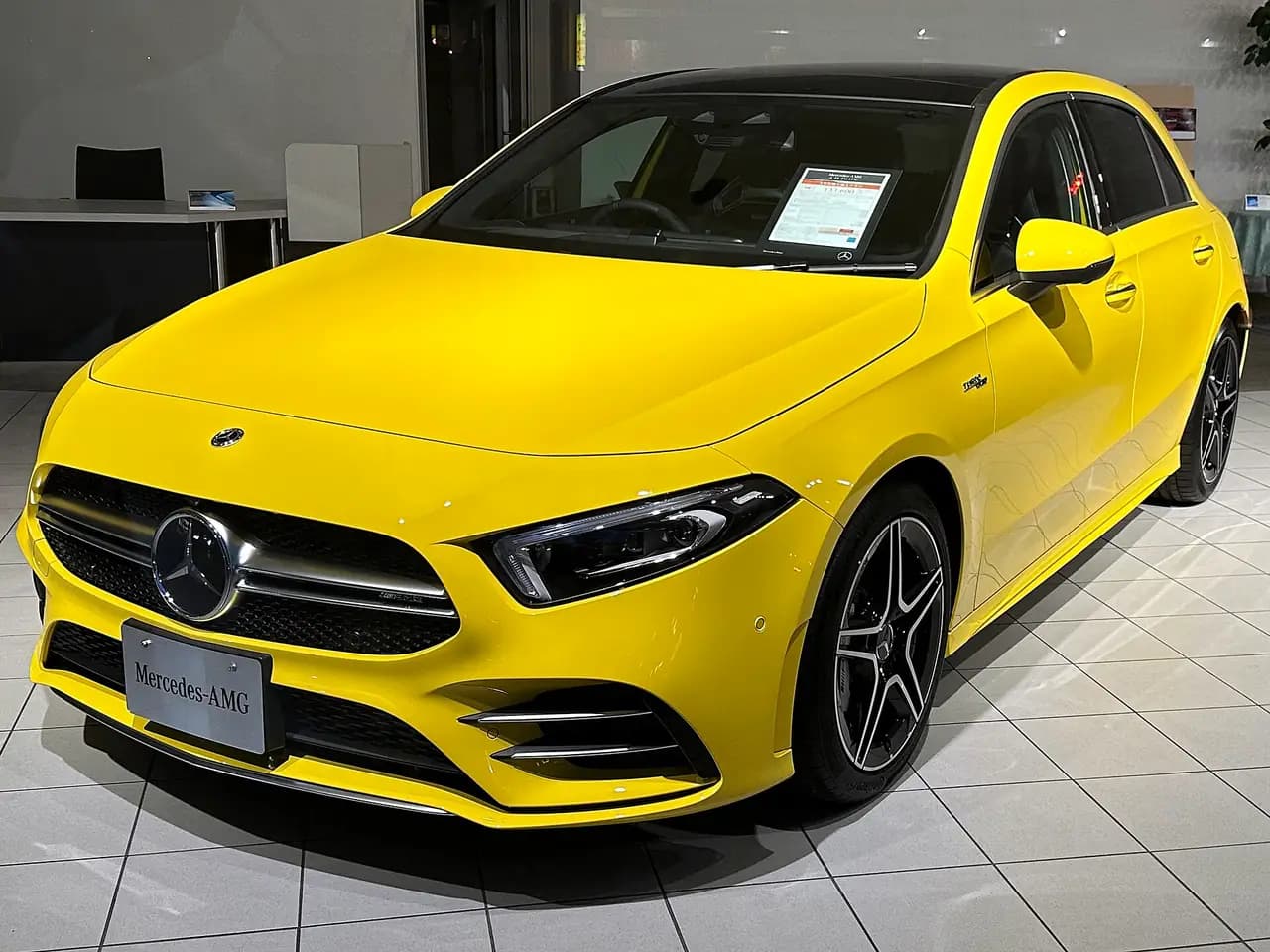 Yellow Mercedes-AMG A 35 4MATIC hatch (W177, pre-facelift), front three-quarter view