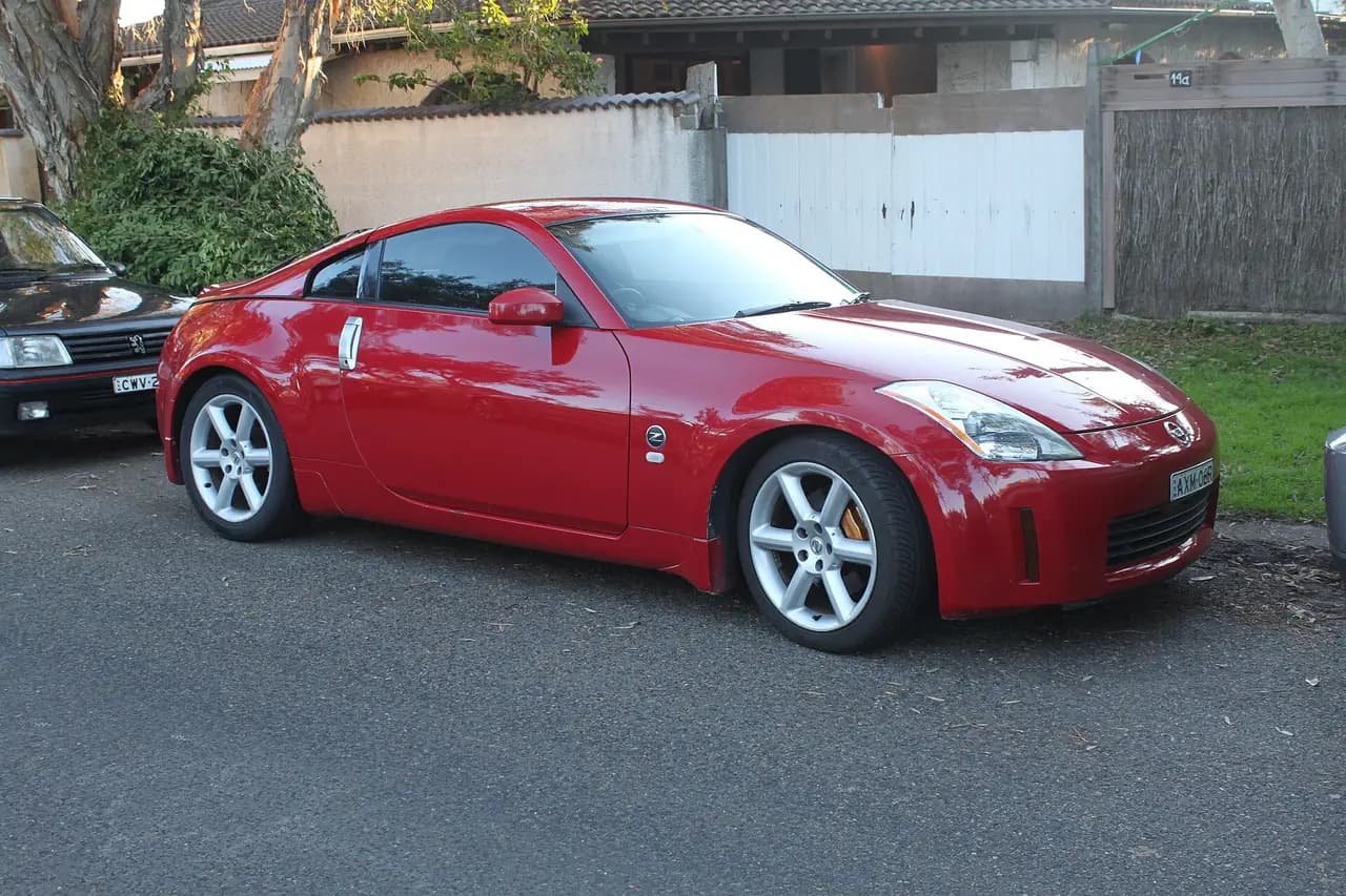 Red 2003 Nissan 350Z Track (Z33) coupe, front three-quarter view