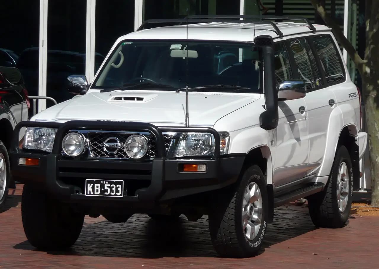 White 2008 Nissan Patrol (GU Series 6) ST-L wagon with bull bar and snorkel, front three-quarter view