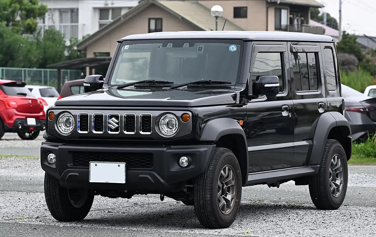 Black 2025 Suzuki Jimny 5-door (JC74), front three-quarter view