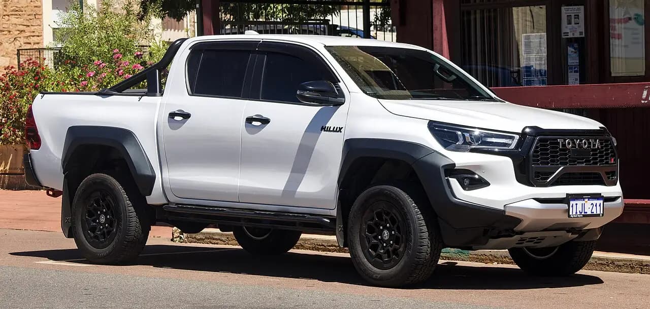 White 2024 Toyota HiLux GR Sport double cab with wide black flares, front three-quarter view