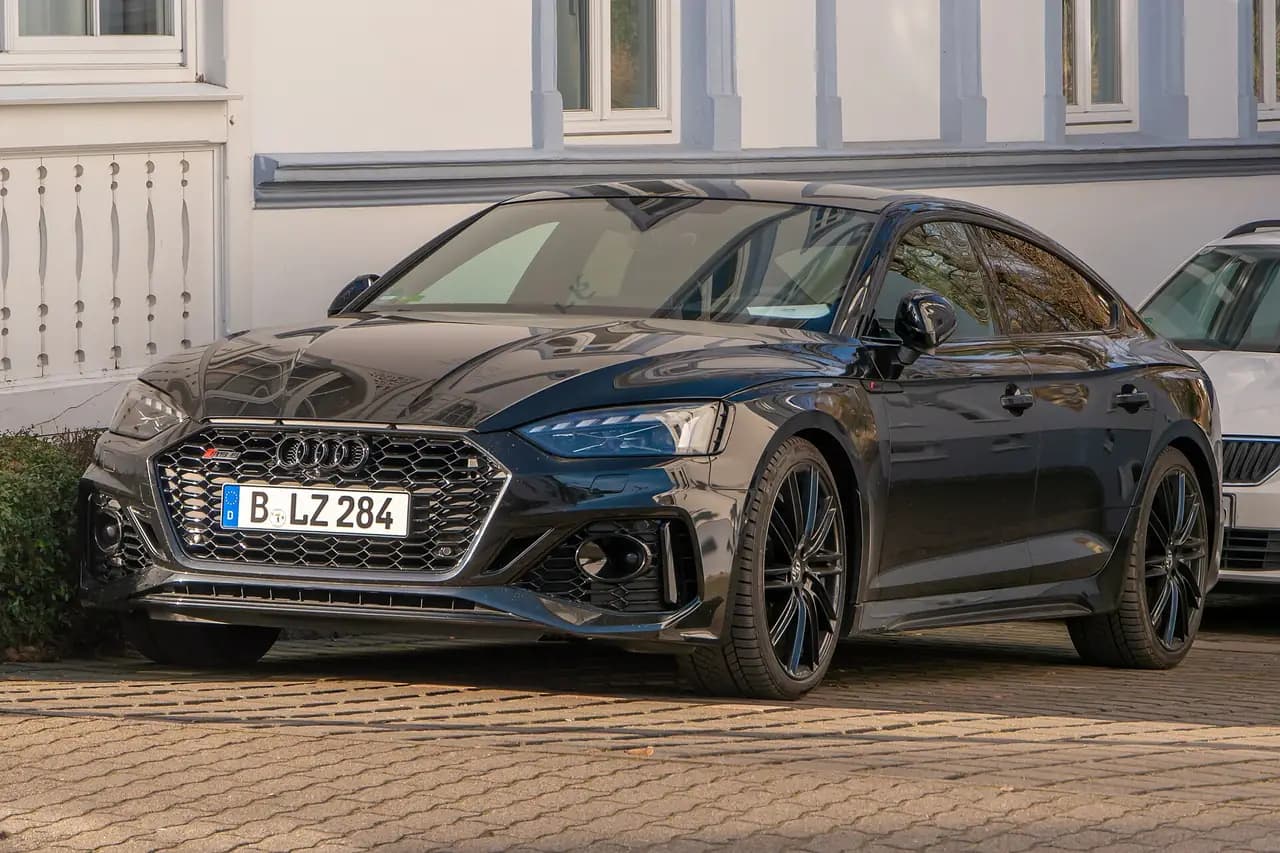 Black Audi RS5 Sportback (B9.5 facelift) parked on a street, front three-quarter view