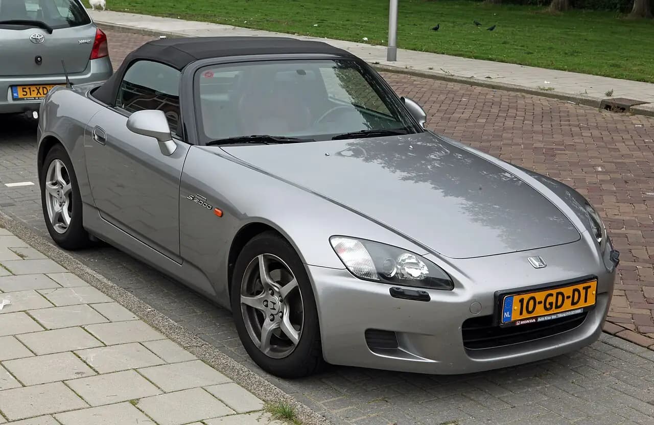 Silver 2000 Honda S2000 (AP1) roadster with soft top up, front three-quarter view