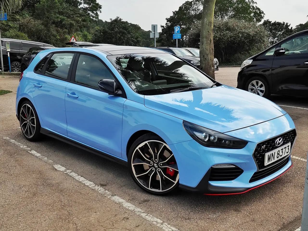 Performance Blue 2019 Hyundai i30 N hatch (PDe), front three-quarter view in a car park