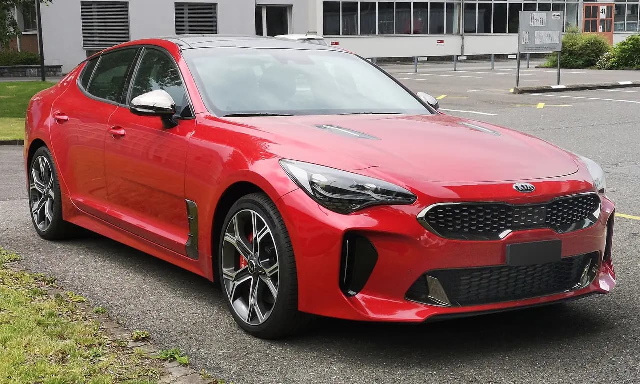 Red Kia Stinger GT (CK) fastback, pre-facelift, front three-quarter view