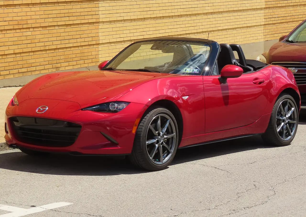 Soul Red 2016 Mazda MX-5 (ND) roadster, roof down, front three-quarter view