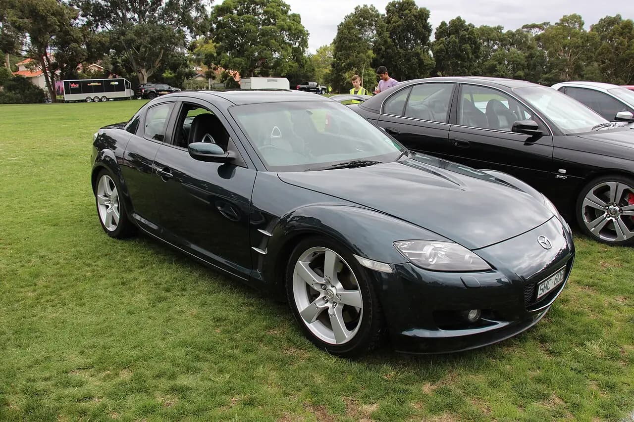 Dark green 2003 Mazda RX-8 (SE3P Series 1) coupe, front three-quarter view