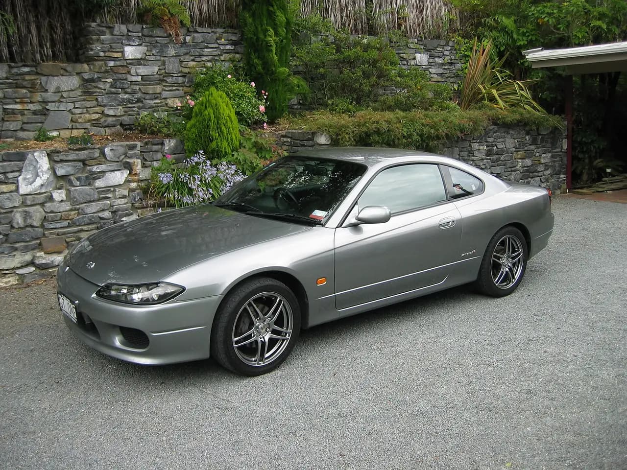 Silver Nissan 200SX Spec-R (S15) coupe on aftermarket wheels, front three-quarter view