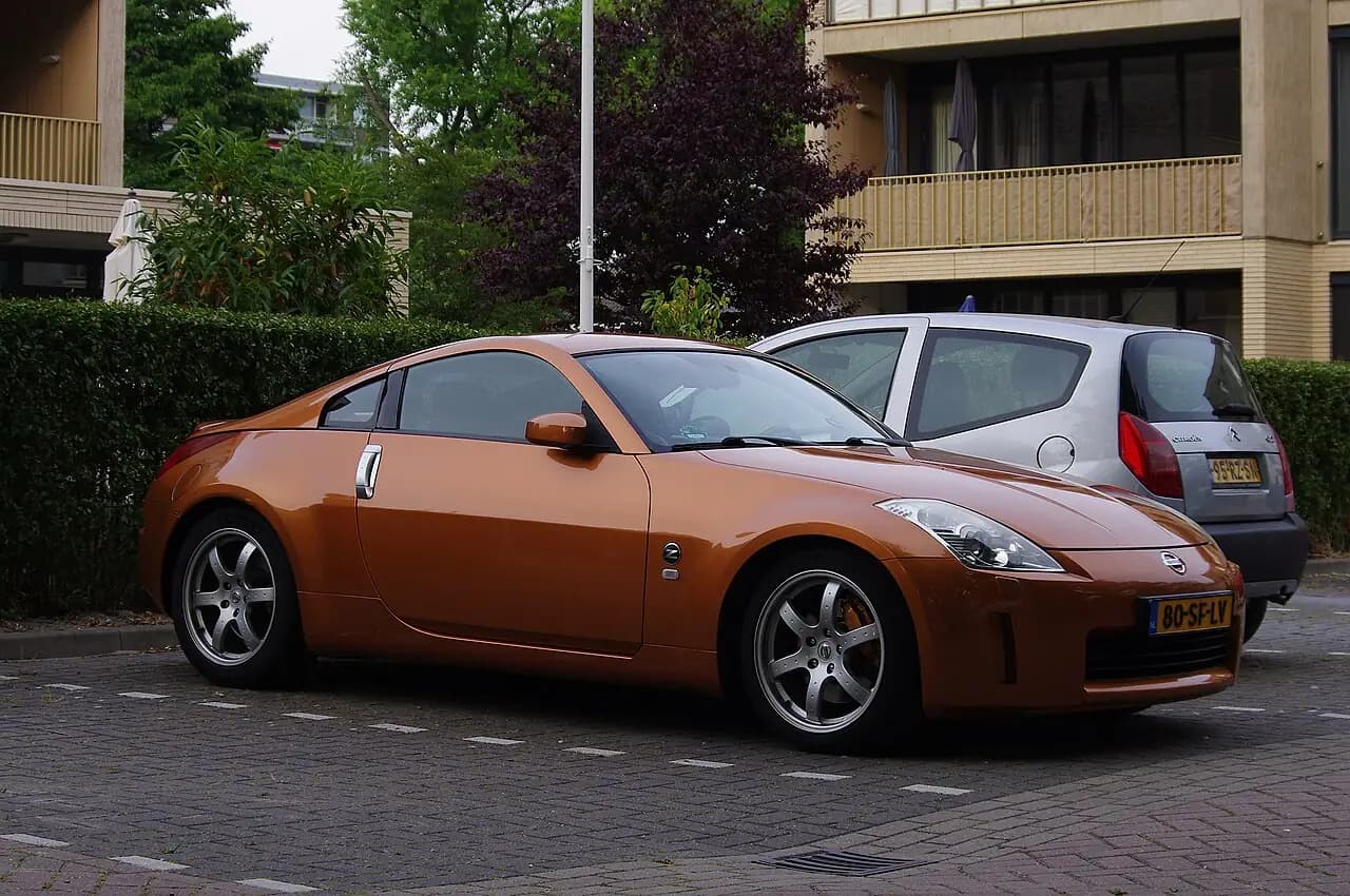 Copper-orange 2005 Nissan 350Z (Z33 facelift) coupe parked on a street, front three-quarter view