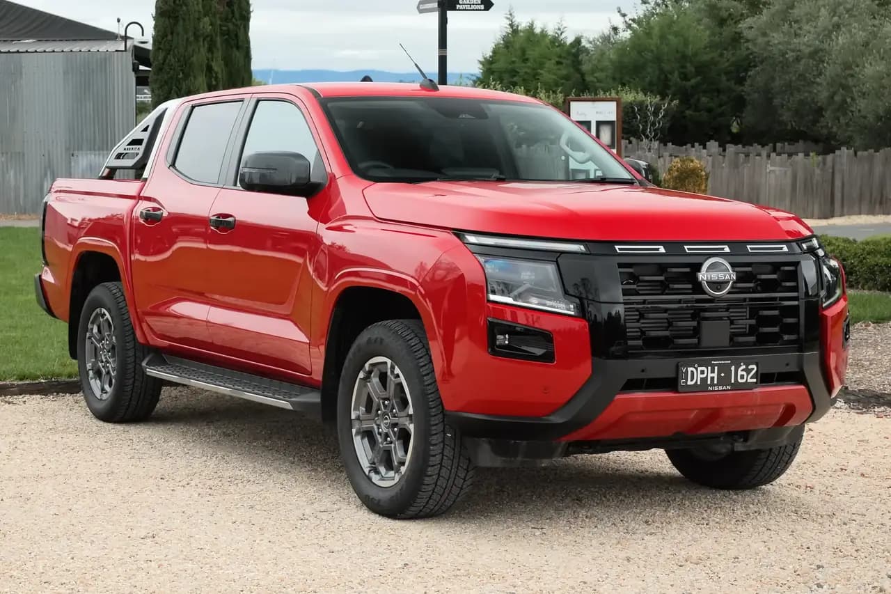 Red 2026 Nissan Navara ST-X dual cab 4x4 (D27), front three-quarter view