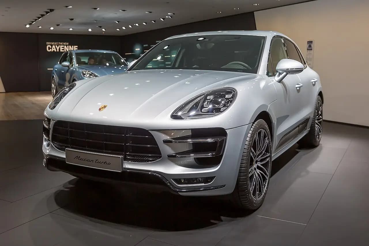 Silver Porsche Macan Turbo (95B) on a show stand at IAA 2017, front three-quarter view
