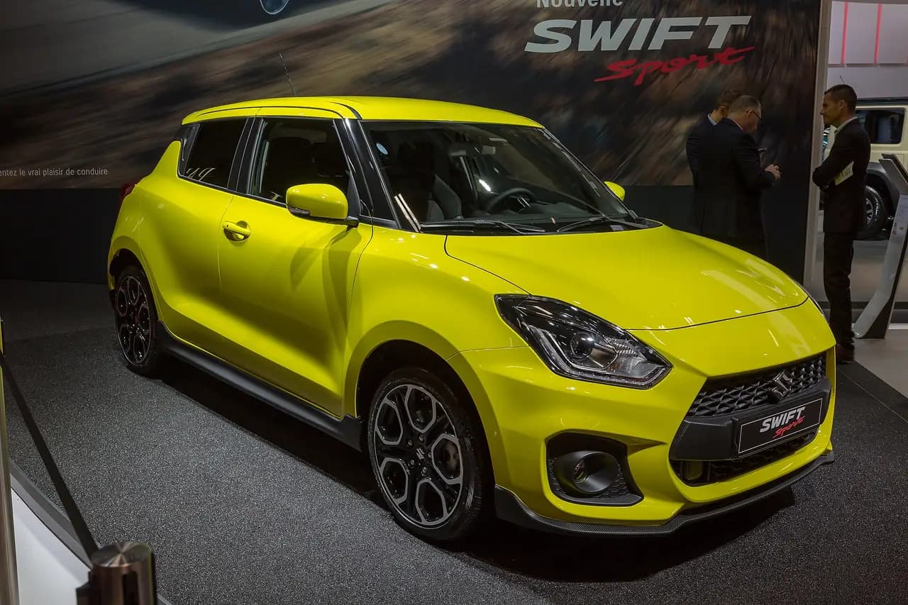 Champion Yellow 2018 Suzuki Swift Sport (ZC33S) hatch at Paris Motor Show, front three-quarter view