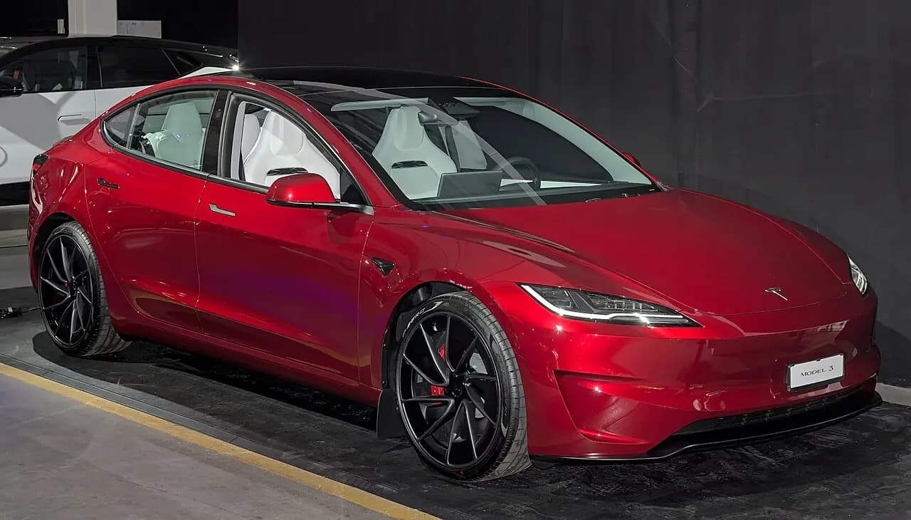 Ultra Red Tesla Model 3 Performance (Highland), front three-quarter view at Auto Zürich 2025