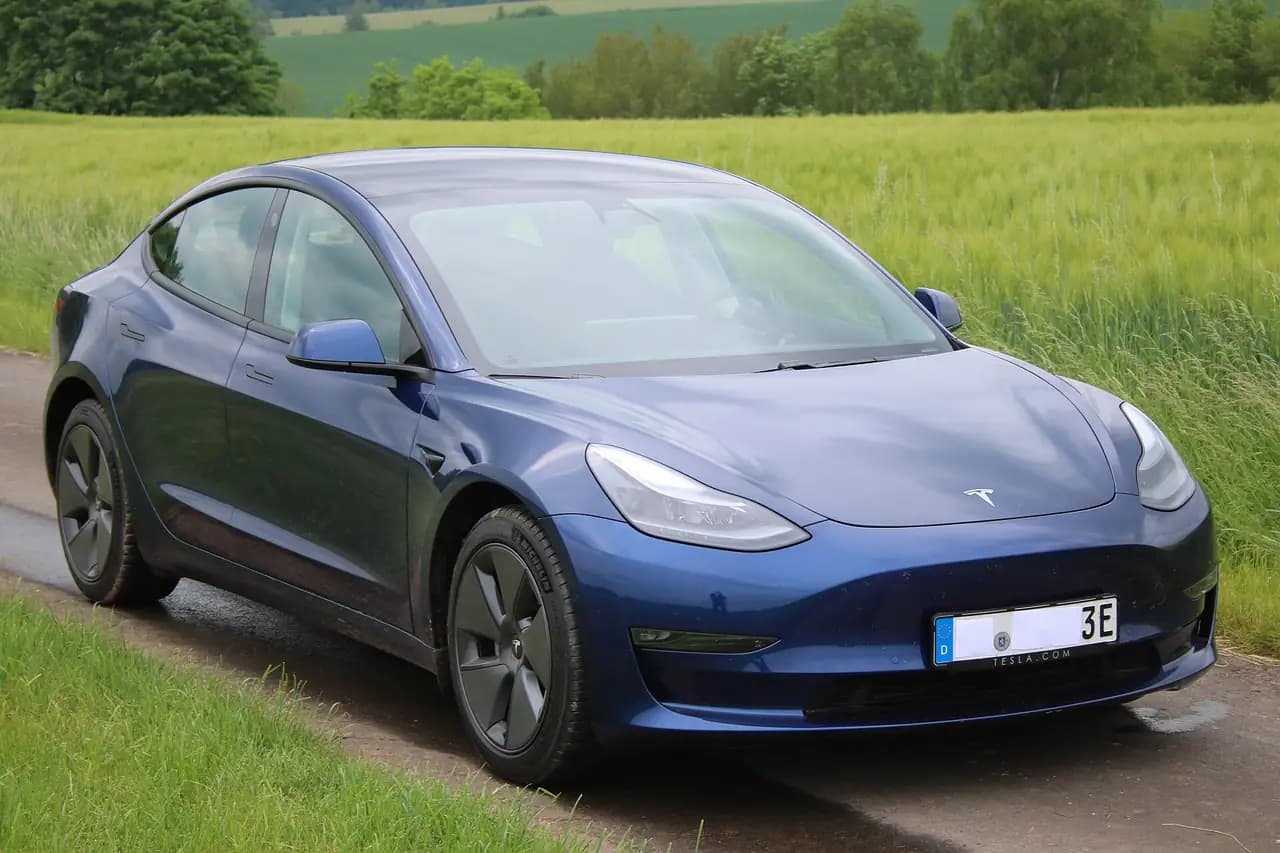 Blue 2021 Tesla Model 3 (pre-Highland), front three-quarter view