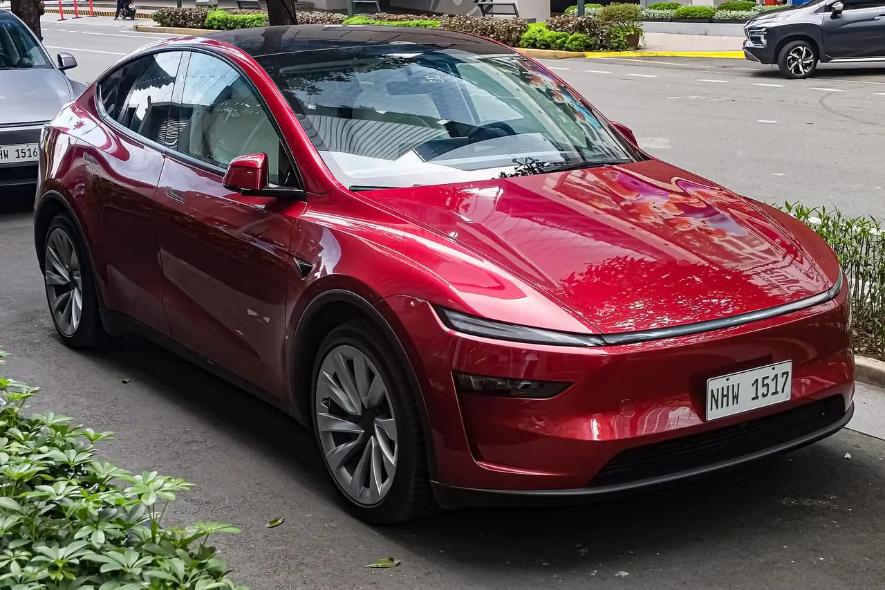 Red Tesla Model Y Long Range AWD (Juniper), front three-quarter view